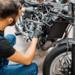 man doet motor onderhouden in garage
